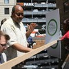 Pianist Brian Neff plays while New York City Housing Authority Youth Chorus director Larry Matthew conducts and turns pages.
